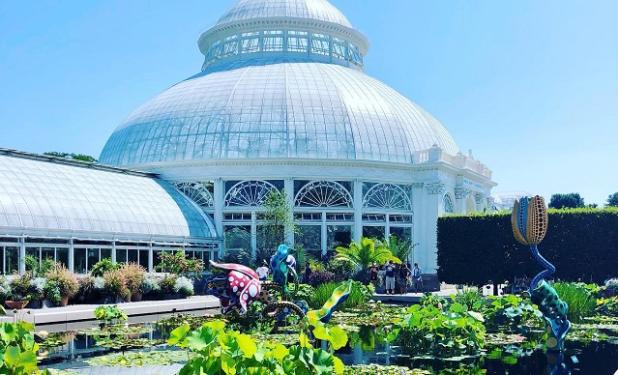A lily pond sits outside the stunning Enid A. Haupt Conservatory greenhouse  at the New York Botanical Garden in the Bronx