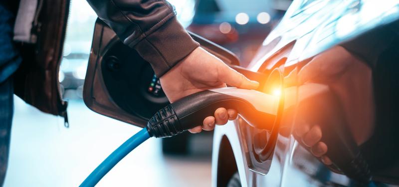 man plugging in car charger