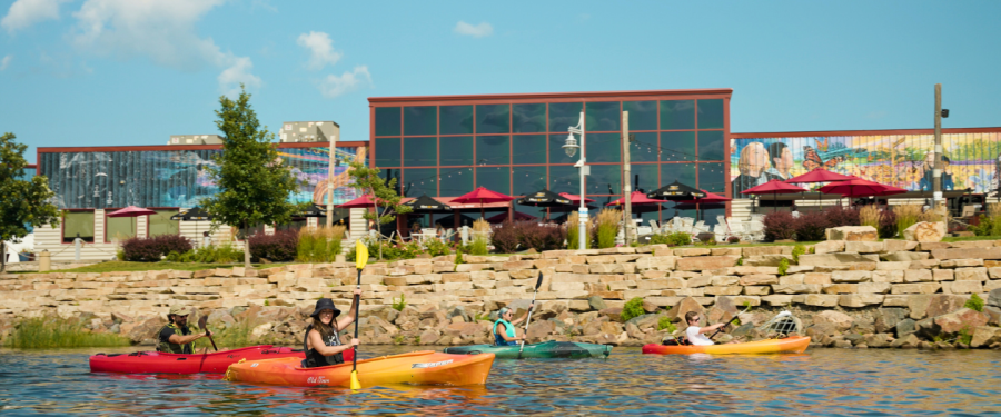 Friends paddling on kayaks near downtown Wausau