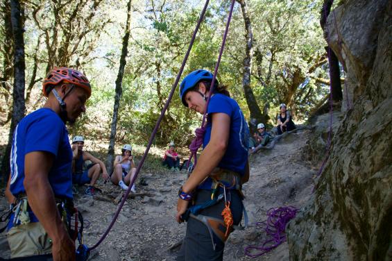 Rock climbers adjusting ropes