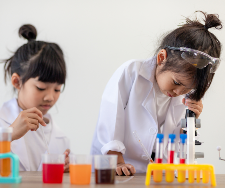 Two children looking at test tubes