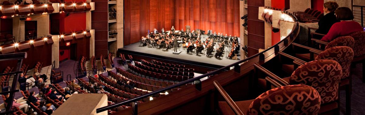 an orchestra on a stage in a theater