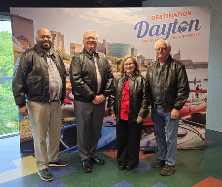 The Destination Dayton 2026 Community Ambassador Award winners standing in front of a Dayton-themed backdrop