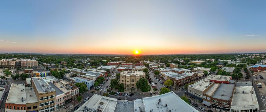Yellow sun setting over the skyline in Downtown McKinney