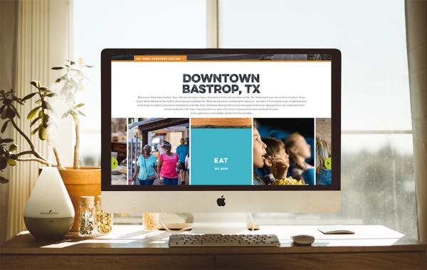 Downtown Barstrop, TX microsite is visible on an Apple computer screen.