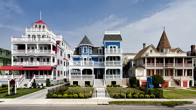 Images of three, large properties in Cape, May New Jersey. One property is red, another is blue, and the final one is brown.
