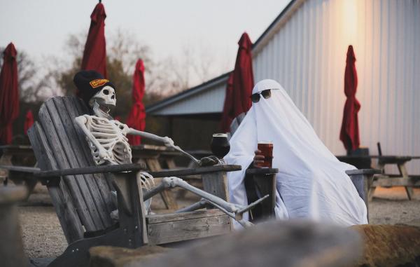 A ghost and skeleton having beers at Henmick Farm Brewery in Columbus