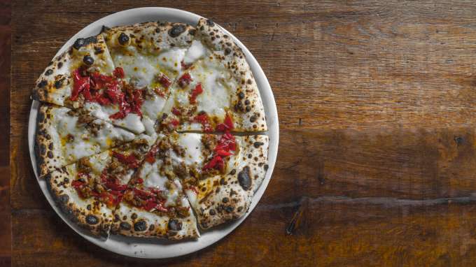 Personal pizza on a wooden table for Oakland Restaurant Week 2020
