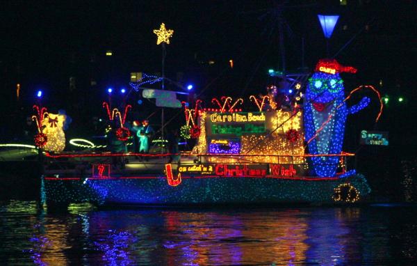 Island of Lights Flotilla lit up with sign that says, "Carolina Beach Fishing Pier"