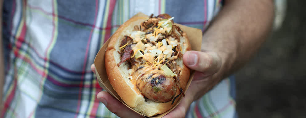 Wiener Kitchen Ultimate Royals Baseball Tailgate Man with bratwurst in hand