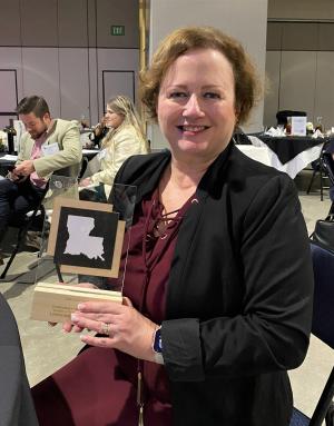 St. Tammany Parish Tourist Commission President and CEO Donna O'Daniels holds the Louey Award for Outstanding CVB TC of the Year (budget over $1 million).