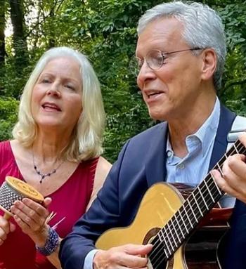 a man and a woman with gray hair singing