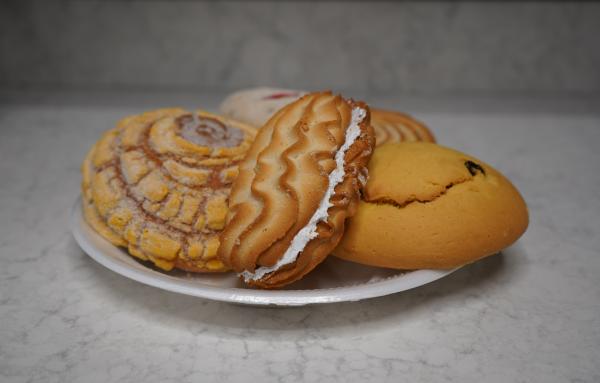A pastry filled with cream sits on top of a concha from Diaz Bakery in Fort Smith, Arkansas.