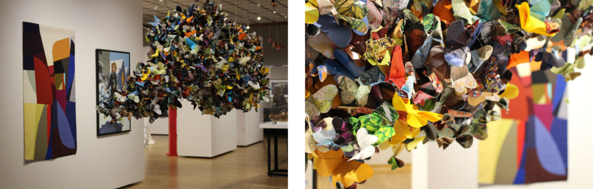 Exhibit at Muskegon Museum of Art showcasing different styles of artwork; on the left is a colorful abstract geometric painting, and in the center a suspended sculpture composed of a cluster of multicolored butterflies.