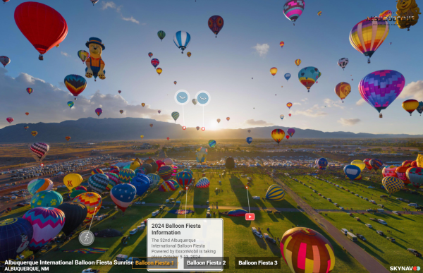 A screenshot of Visit Albuquerque's interactive mixed reality web experience using Skynav. Dozens of multi-colored hot air balloons soar through a bright blue sky as the sun rises over mountains in the distance.