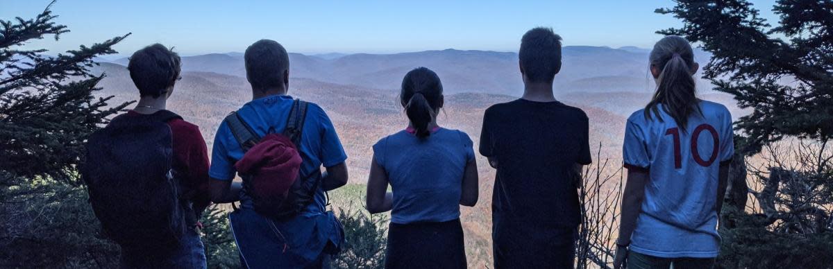 Five teens looking out over the high peaks