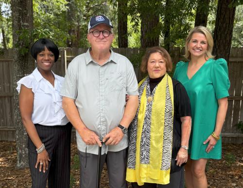Tim and Jan Lantrip of The English Tea Room along with Zondra and Katie smile for the camera outside Northshore Media Group studios.