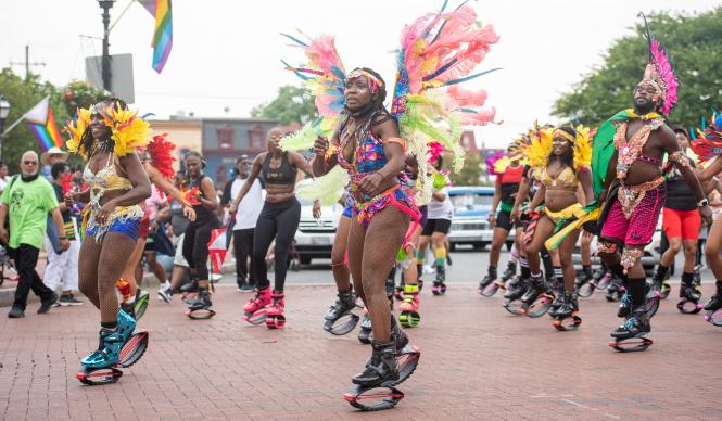 A group of black people in costumes march in the Juneteenth parade in Annapolis, MD.