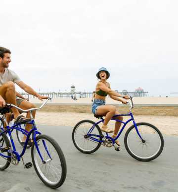 Couple riding bikes in Huntington Beach