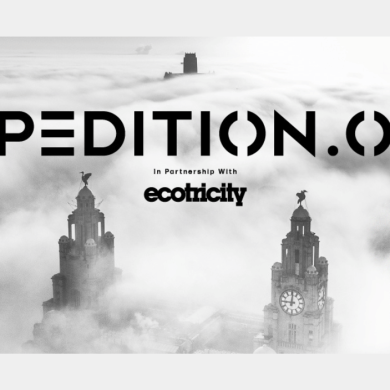 A black and white photo of the Royal Liver Building in clouds.