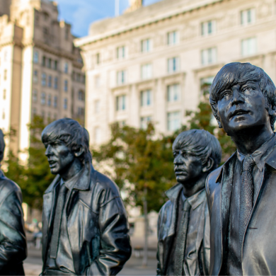 The Beatles statues with the Cunard and Liver building behind them.