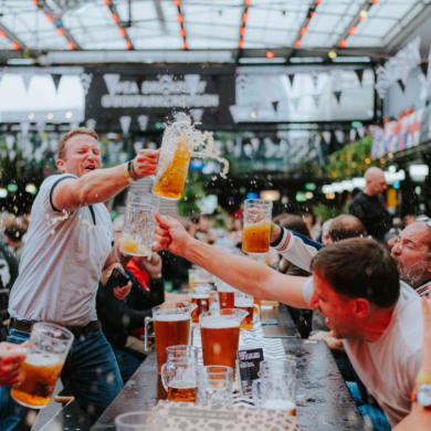 Men cheersing their beer at Boxpark