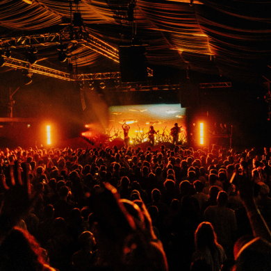 Inside Content Liverpool with a large crowd and orange lights.