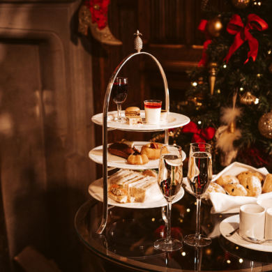 Afternoon tea on a table next to a Christmas tree.