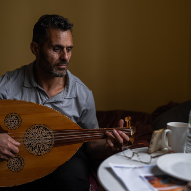 Man playing guitar at a table.