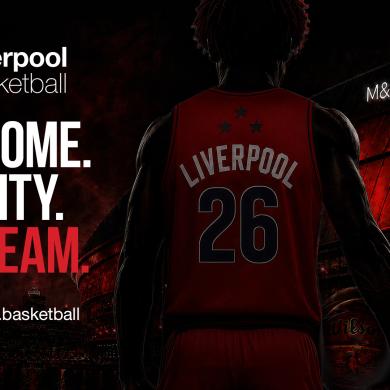 Promotional poster for Liverpool Basketball featuring the back view of a basketball player wearing a red Liverpool jersey with the number 26, holding a basketball in front of the illuminated M&S Bank Arena at night. The design uses a black and red colour scheme with the Liverpool Basketball logo and the slogan: “OUR HOME. OUR CITY. OUR TEAM.” A website address, www.liverpool.basketball, appears at the bottom left.