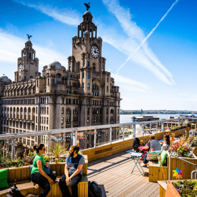 The Royal Liver Building with a rooftop bar in front of it.