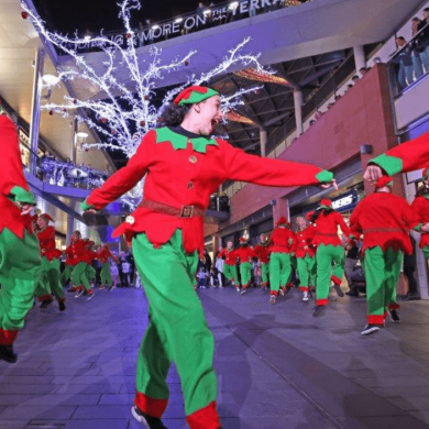 People dancing in Liverpool one dresses as elves.