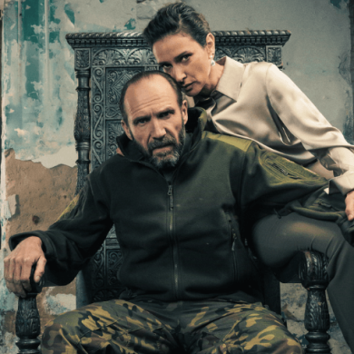 Two people sitting on a chair in a warehouse style building.
