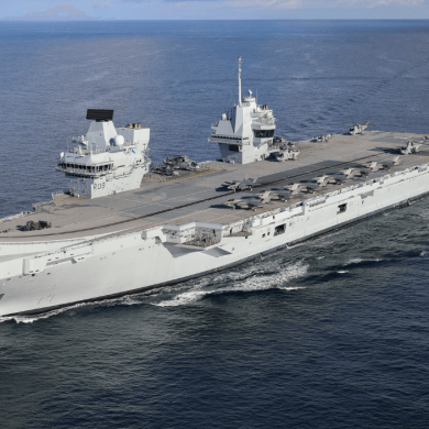 A large navy vessel on water.