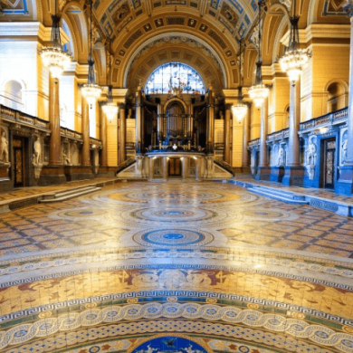 Inside of St George's Hall with elaborate tiles on the floor.