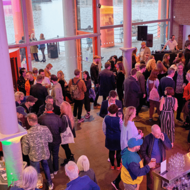 Inside Tate Liverpool with a crowd of people in the entrance space.