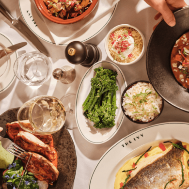 A table with plates of food on at The Ivy.