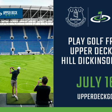 Promotional graphic showing a golf experience inside a large football stadium with rows of blue seats and a bright green pitch marked with circular golf targets. In the foreground, several people stand on a raised platform hitting golf balls toward the field while one person records on a phone. A banner above the seating reads “Upper Deck Golf.” On the right side, a navy panel displays the Everton crest alongside the Upper Deck Golf logo and text reading: “Play golf from the upper deck inside Hill Dickinson Stadium. July 16–19. upperdeckgolf.com.”