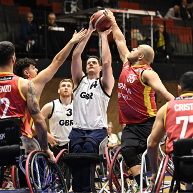 A group shot of people playing wheelchair basketball.