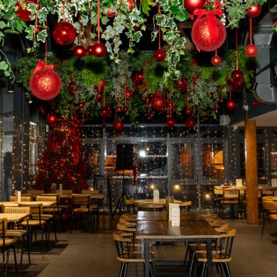 The Lake House decorated with red baubles and fairy lights for Christmas