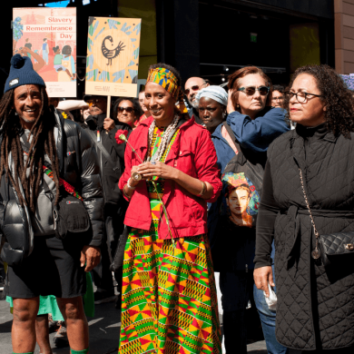A group of people walking together and smiling as they take part in a Walk of Remembrance.