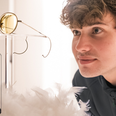 A man staring at a pair of glasses