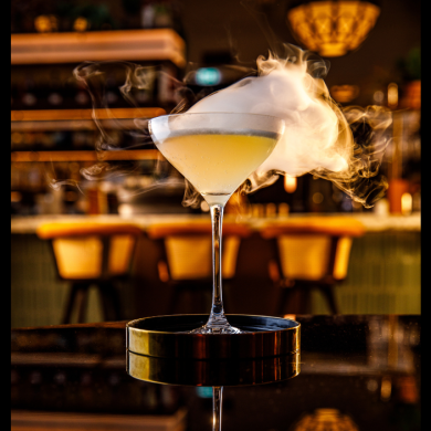 A cocktail with smoke coming off.