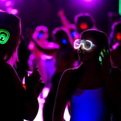 Visitors at Chester Zoo enjoying a silent disco with neon headphones and light up rave glasses