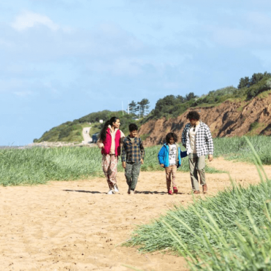 A family walk along the beach in Wirral