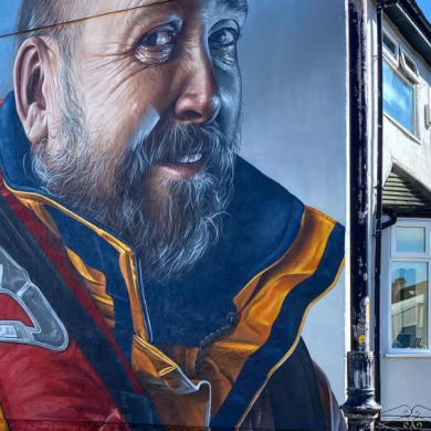 Street art in New Brighton on the side of a house showing a RNLI coastguard
