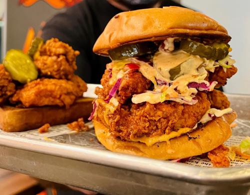 Two chicken sandwiches balanced on a tray.