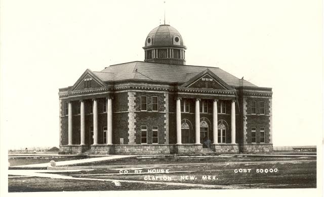 A vintage black and white photo shows the Union County Courthouse in Clayton, NM.