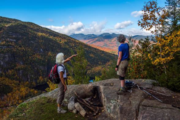 Giant Mountain, Keene Valley Two seniors lookout at a view of fall foliage over the Adirondacks from Giant Mountain Keene Valley