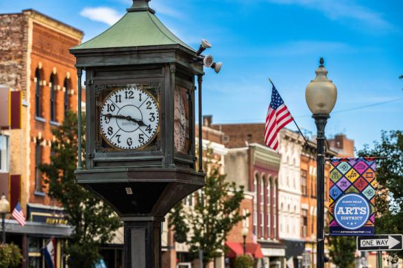 Glens Falls Art District A clocktower in front of a view of downtown Glens Falls